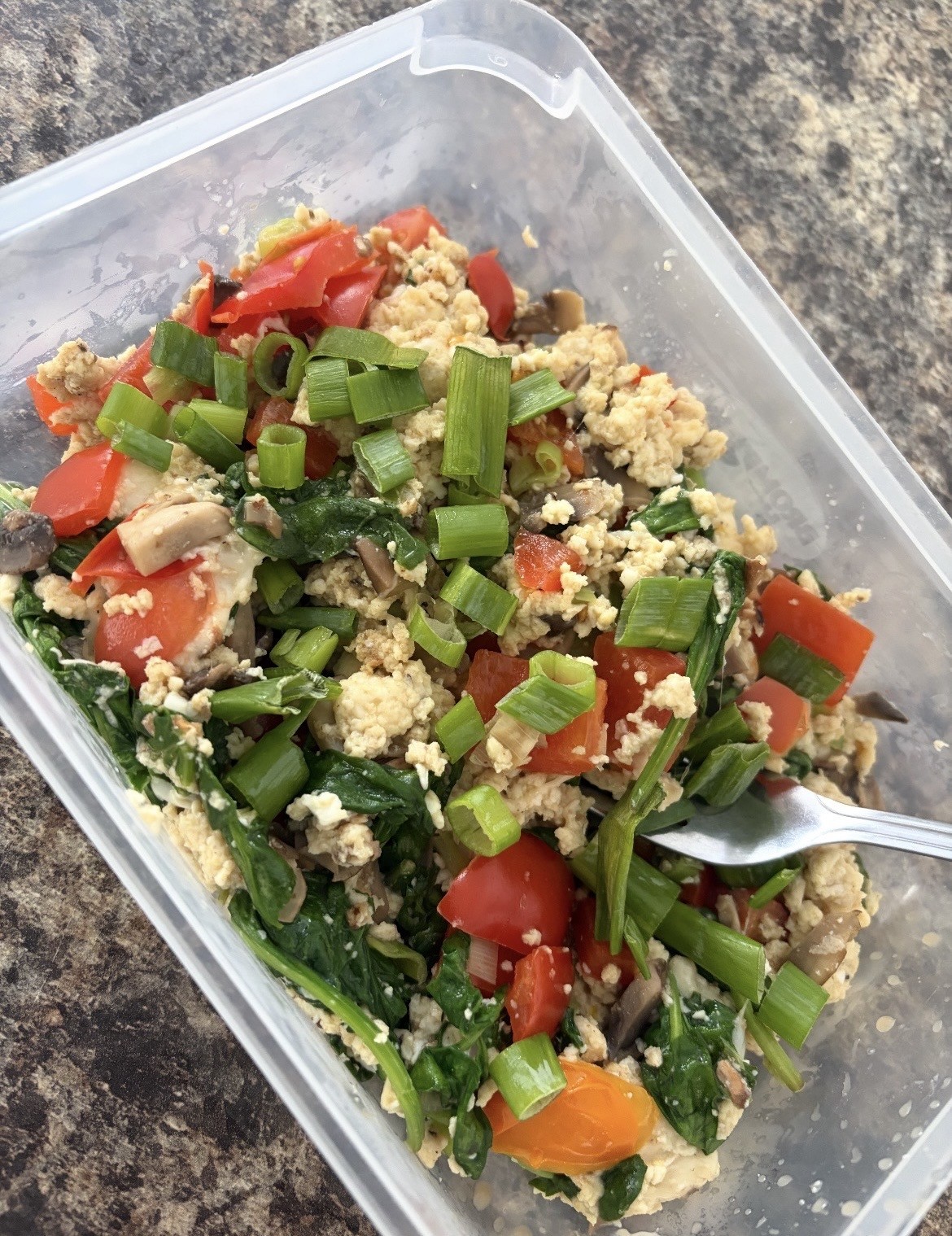 A client's meal prep β egg scramble with spinach, tomatoes and spring onions